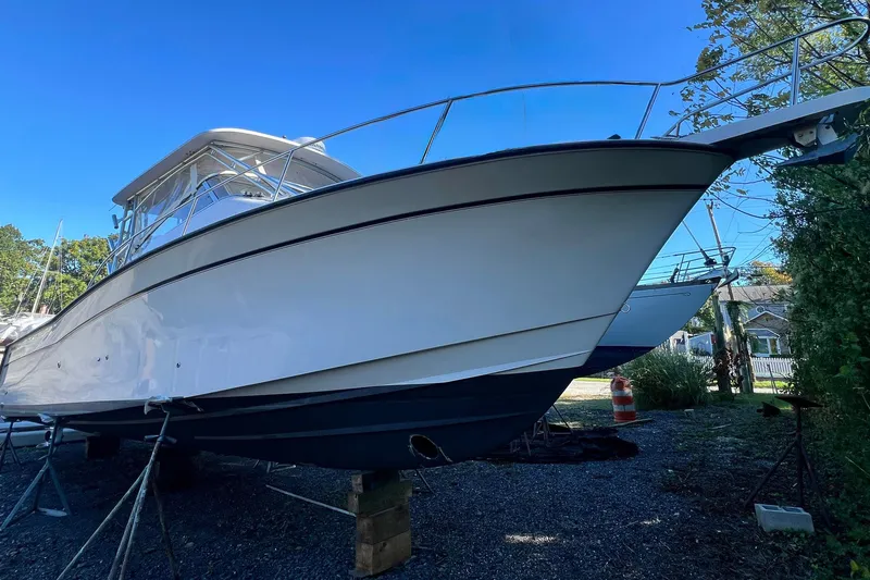 Zig Zag Yacht Photos Pics 2004 Grady-White Express 330 boat on stands, clear blue sky background.