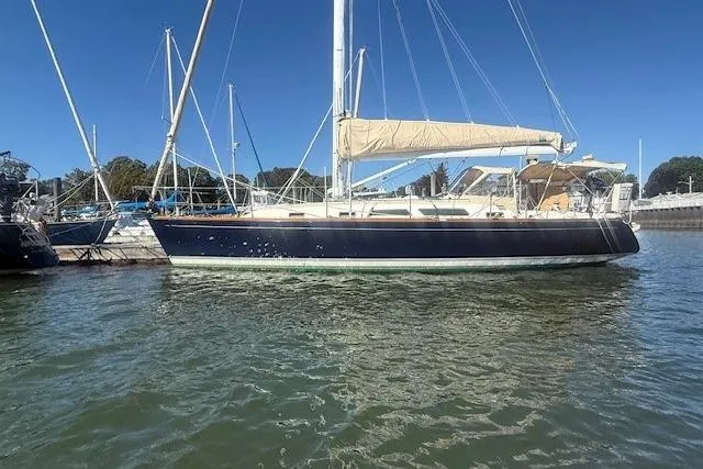 Midnight Yacht Photos Pics 2005 Sabre 386 sailboat docked in marina under clear blue sky.