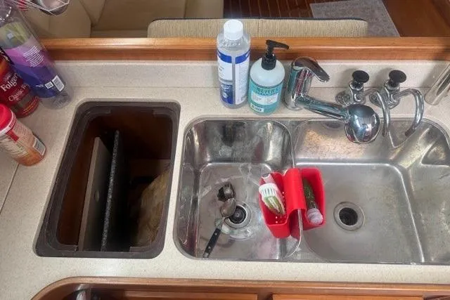 Midnight Yacht Photos Pics Galley sink area on 2005 Sabre 386 yacht with cleaning supplies and utensils.