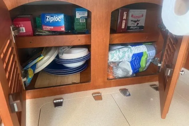 Midnight Yacht Photos Pics Cabinet storage on 2005 Sabre 386 yacht with plates, Ziploc bags, and paper towels.