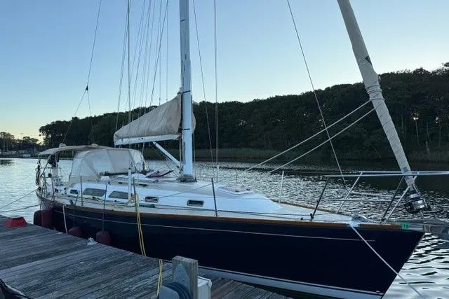Midnight Yacht Photos Pics Sailboat docked at sunset, 2005 Sabre 386 model, calm water background.