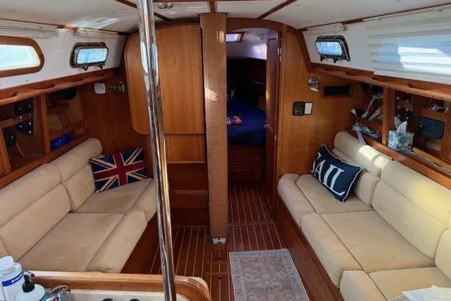 Midnight Yacht Photos Pics 2005 Sabre 386 yacht interior with beige seating, wooden finish, and nautical decor.