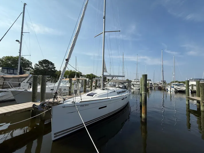 Ma Bro Yacht Photos Pics 2014 Jeanneau Sun Odyssey 409 sailboat docked in a marina under a clear blue sky.
