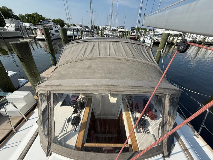 Ma Bro Yacht Photos Pics 2014 Jeanneau Sun Odyssey 409 sailboat docked at a marina, featuring a covered cockpit.