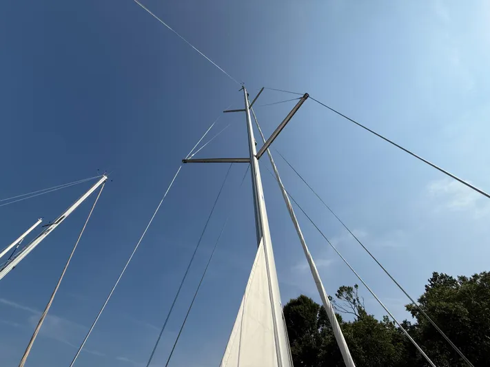 Ma Bro Yacht Photos Pics Mast of 2014 Jeanneau Sun Odyssey 409 sailboat against clear blue sky.