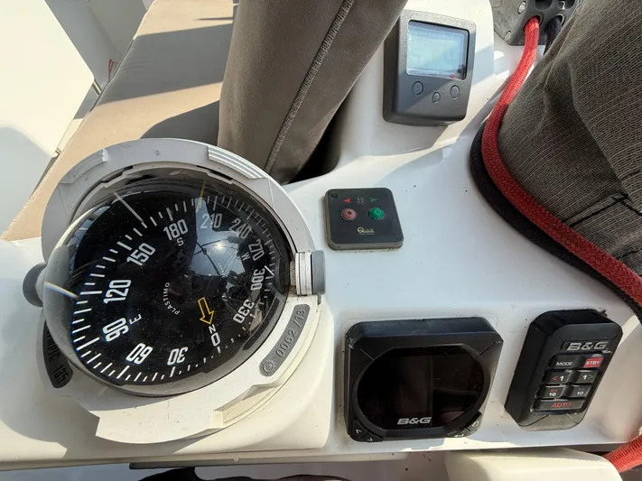 Ma Bro Yacht Photos Pics Cockpit instruments of a 2014 Jeanneau Sun Odyssey 409 sailboat, featuring a compass and navigation controls.