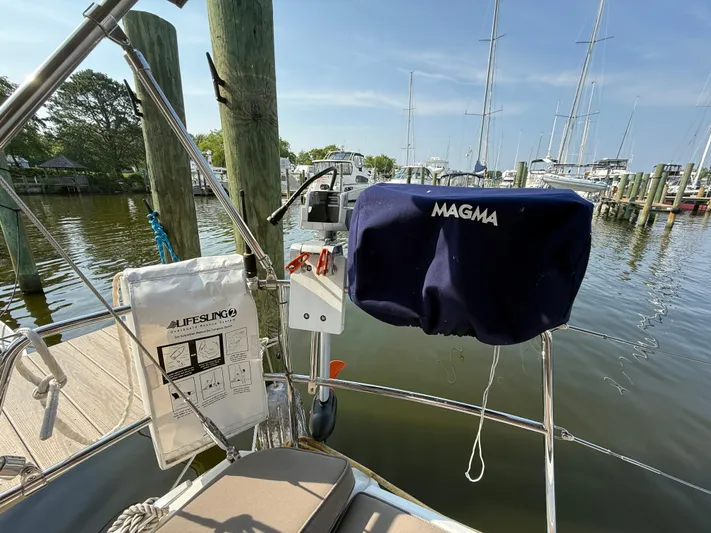 Ma Bro Yacht Photos Pics Jeanneau Sun Odyssey 409 sailboat deck with Magma grill and safety equipment, docked at marina.