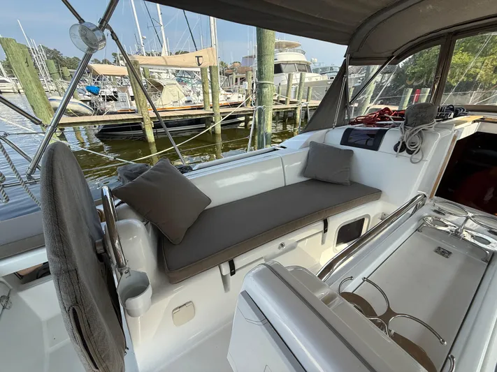 Ma Bro Yacht Photos Pics 2014 Jeanneau Sun Odyssey 409 sailboat cockpit with cushioned seating, docked at marina.