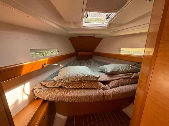 Ma Bro Yacht Photos Pics Cozy cabin interior of 2014 Jeanneau Sun Odyssey 409 sailboat with bed and natural light.