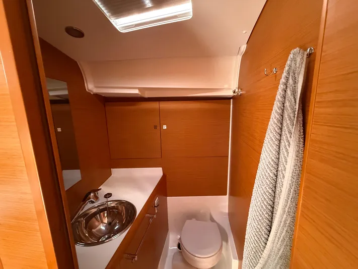 Ma Bro Yacht Photos Pics Bathroom interior of 2014 Jeanneau Sun Odyssey 409 yacht, featuring sink and toilet.