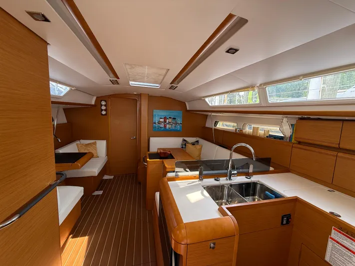 Ma Bro Yacht Photos Pics Interior of 2014 Jeanneau Sun Odyssey 409 yacht, featuring modern kitchen and seating area.