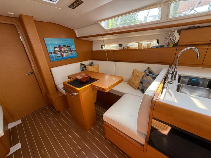 Ma Bro Yacht Photos Pics 2014 Jeanneau Sun Odyssey 409 interior with wood finish, dining area, and modern kitchen.