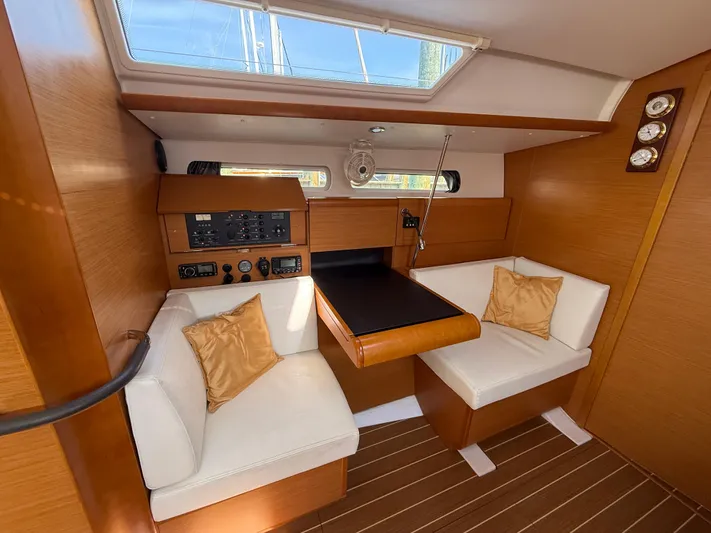 Ma Bro Yacht Photos Pics Interior of 2014 Jeanneau Sun Odyssey 409 sailboat with wood finish and white seating.