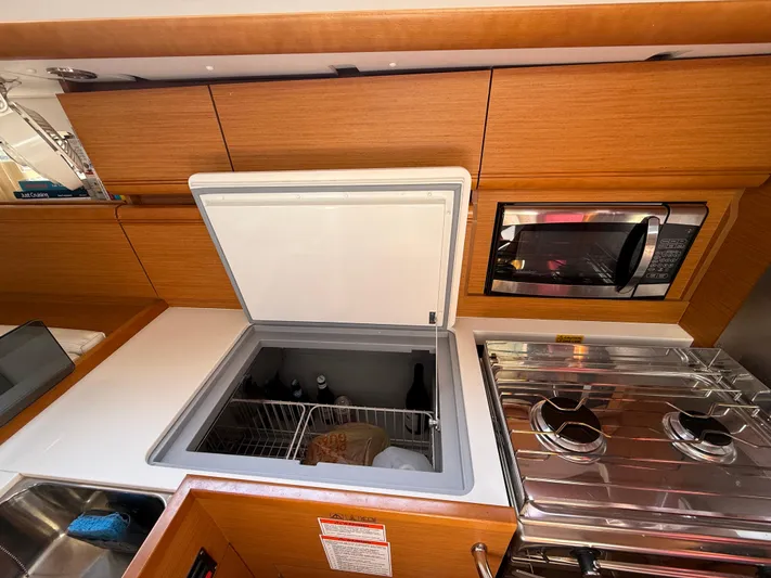Ma Bro Yacht Photos Pics 2014 Jeanneau Sun Odyssey 409 yacht kitchen with open fridge, microwave, and stove.