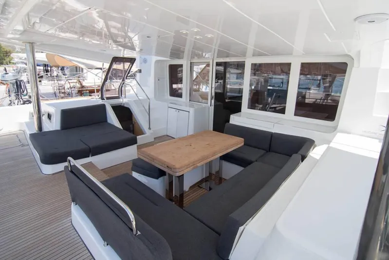 Costabella Yacht Photos Pics Spacious deck of 2018 Lagoon 52 F catamaran with comfortable seating and wooden table.