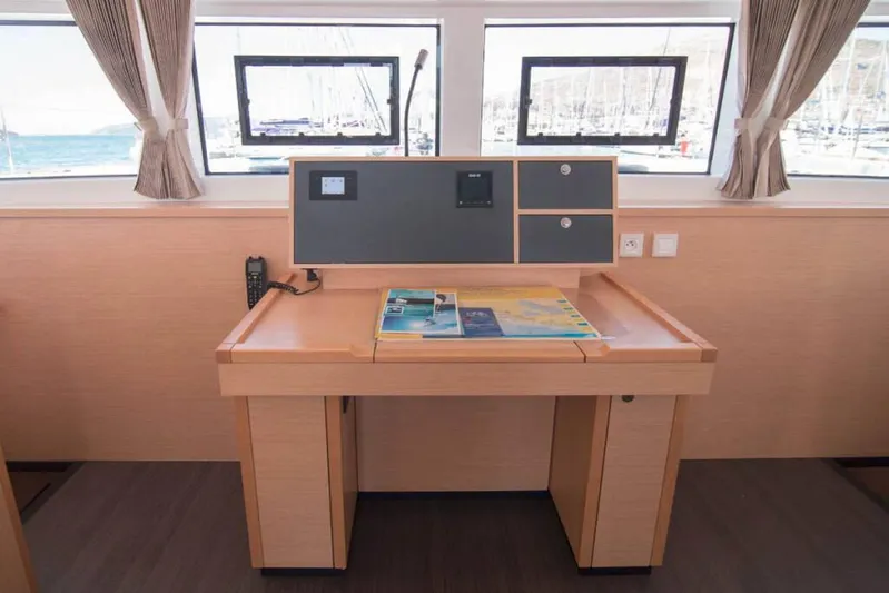 Costabella Yacht Photos Pics Navigation desk inside 2018 Lagoon 52 F yacht with windows and charts.