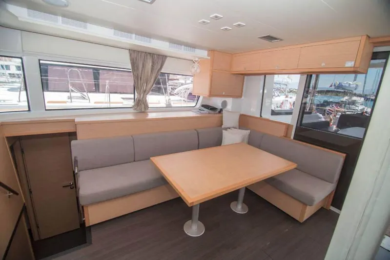 Costabella Yacht Photos Pics Interior of 2018 Lagoon 52 F yacht with modern dining area and large windows.