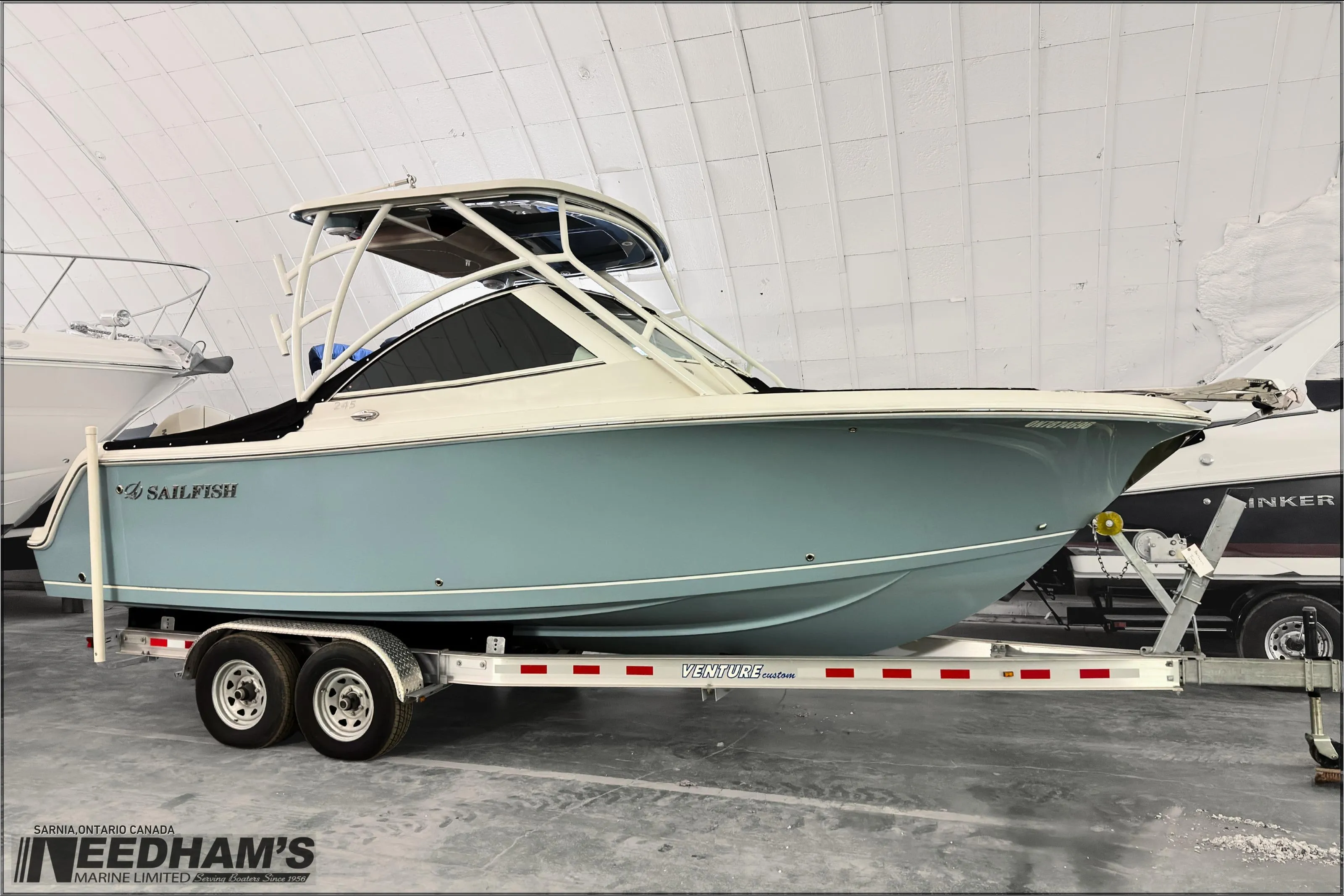 2021 Sailfish 245 DC boat on trailer in indoor storage facility.
