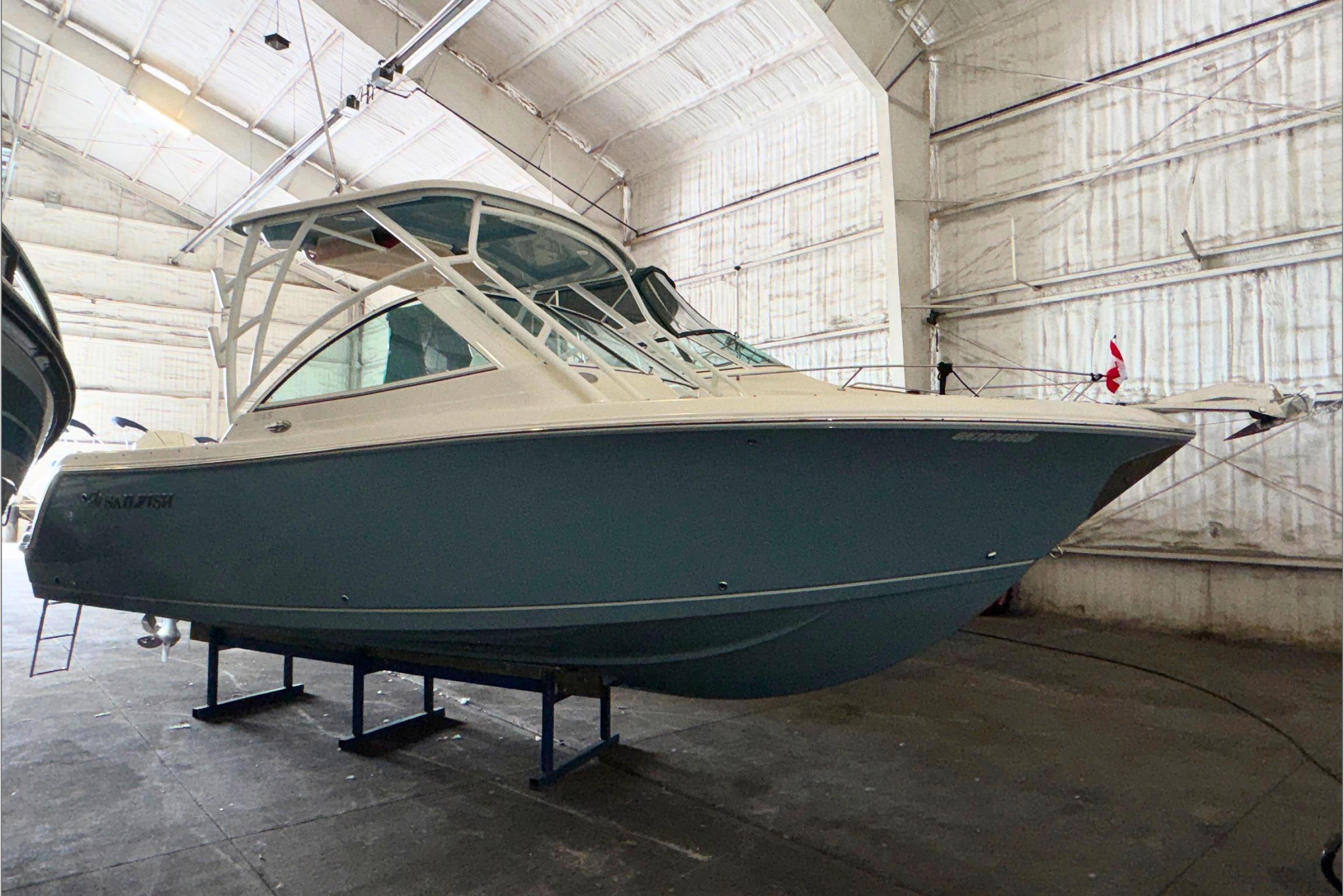 2021 Sailfish 245 DC boat in a spacious indoor storage facility.