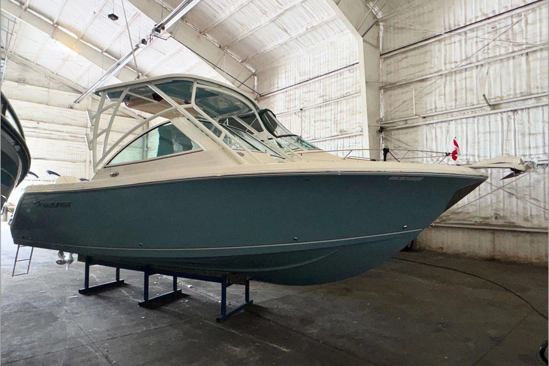 2021 Sailfish 245 DC boat in a spacious indoor storage facility.