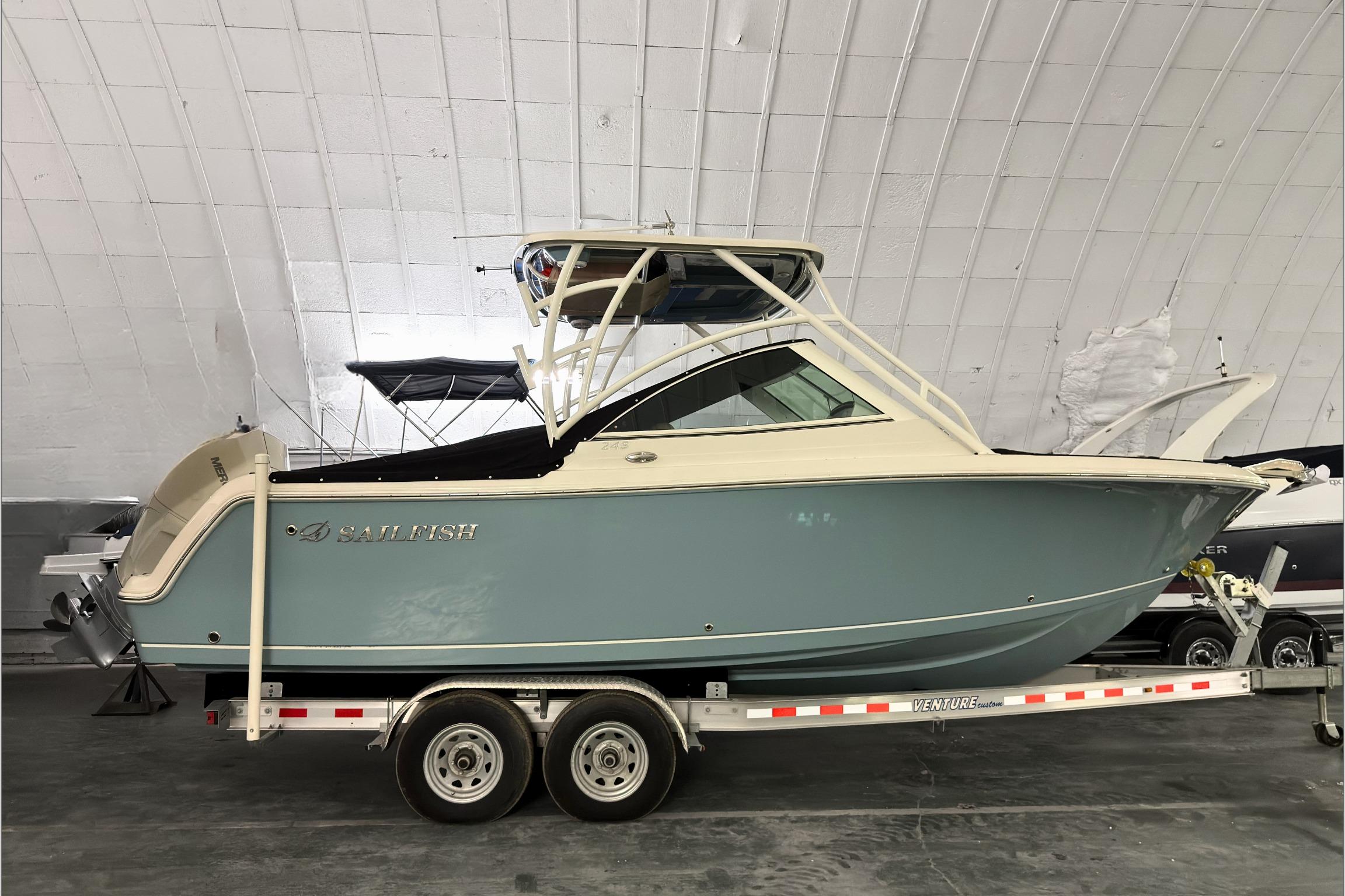 2021 Sailfish 245 DC boat on trailer in indoor storage facility.