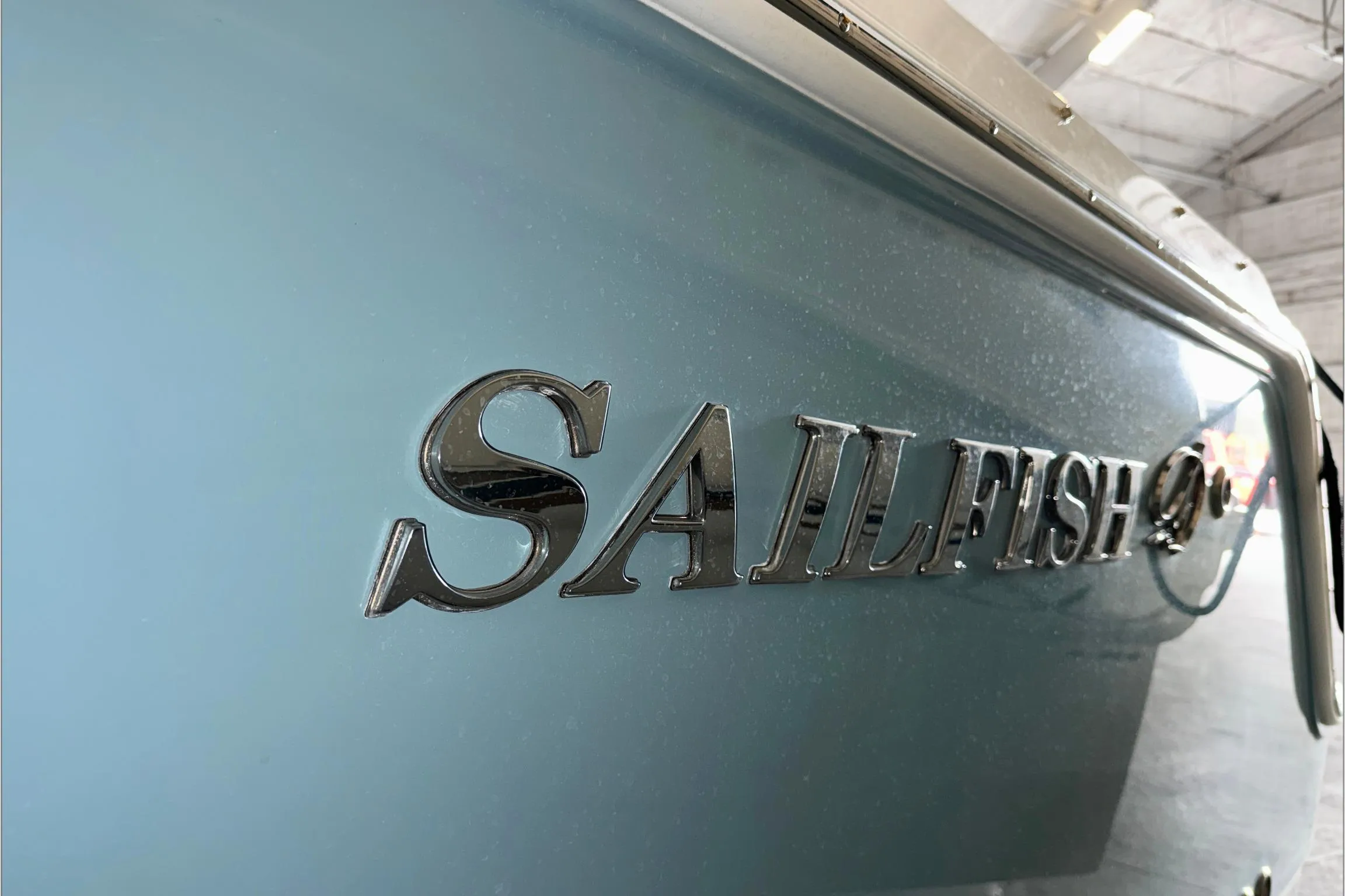 2021 Sailfish 245 DC boat with metallic logo detail.