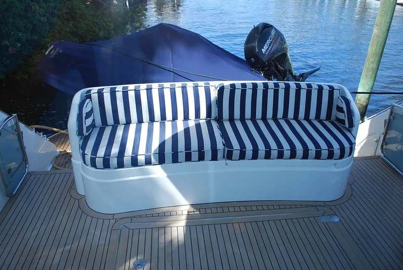 No Name Yacht Photos Pics Striped seating on 2000 Fairline Squadron yacht deck, near water.