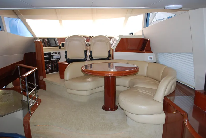 No Name Yacht Photos Pics Luxurious interior of a 2000 Fairline Squadron yacht with plush seating and elegant wood finishes.