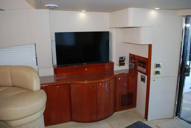 No Name Yacht Photos Pics Interior of 2000 Fairline Squadron yacht with TV and wooden cabinetry.
