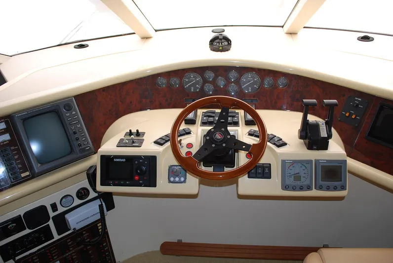 No Name Yacht Photos Pics Cockpit of 2000 Fairline Squadron yacht with steering wheel and navigation instruments.