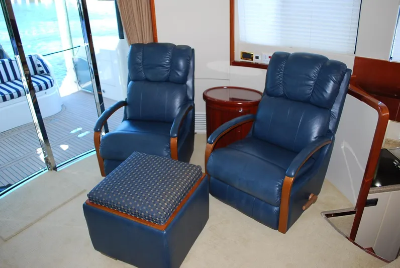 No Name Yacht Photos Pics Luxurious interior of 2000 Fairline Squadron yacht with blue leather chairs and ottoman.