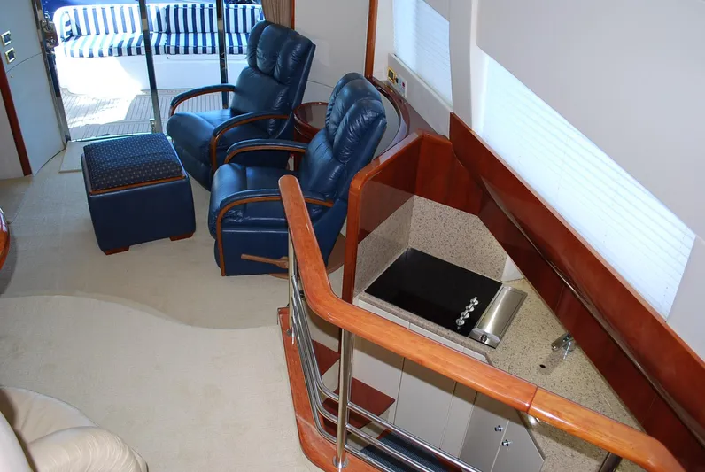 No Name Yacht Photos Pics Interior of 2000 Fairline Squadron yacht with blue leather chairs and modern kitchenette.