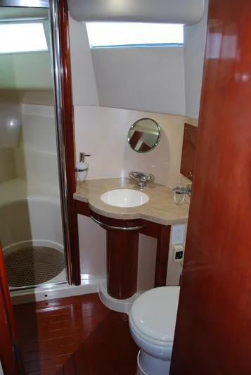 No Name Yacht Photos Pics Luxurious bathroom in 2000 Fairline Squadron yacht with wood accents and modern fixtures.