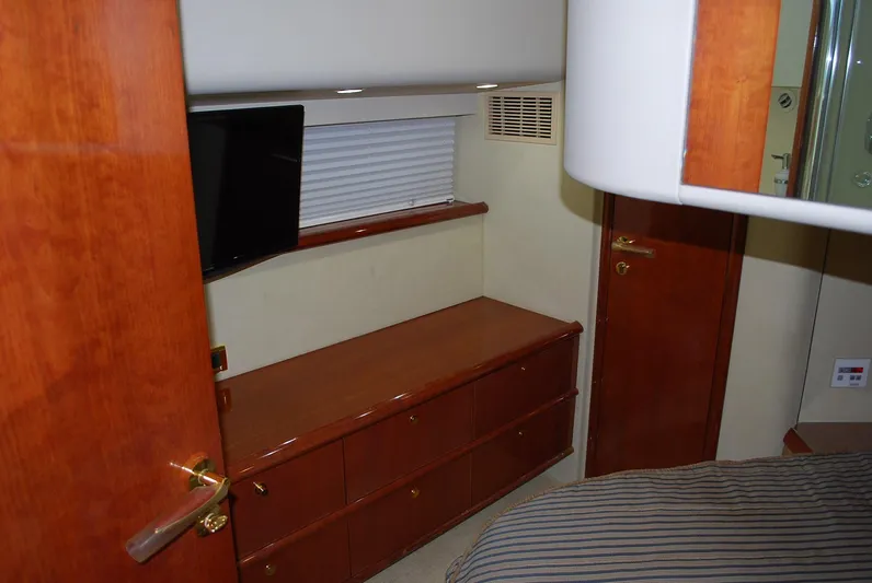 No Name Yacht Photos Pics Interior of 2000 Fairline Squadron yacht with wooden cabinetry and a mounted TV.
