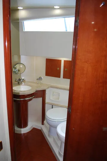No Name Yacht Photos Pics Luxurious bathroom in 2000 Fairline Squadron yacht with wooden accents and modern fixtures.