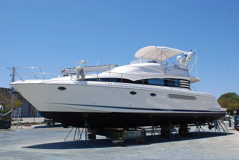 No Name Yacht Photos Pics 2000 Fairline Squadron yacht on dry dock under clear blue sky.