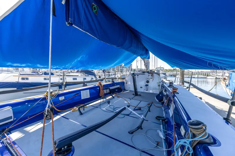 Manifest Yacht Photos Pics 2016 Offshore Racing Van Munster Boats Fred Barrett 35 sailboat with blue canopy in marina.