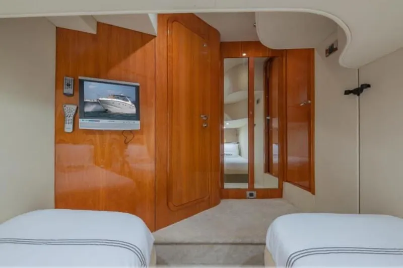  Yacht Photos Pics Interior of 2006 Sunseeker Portofino 47 yacht with wood paneling and TV.