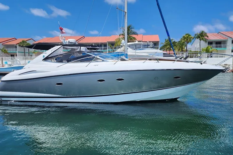  Yacht Photos Pics 2006 Sunseeker Portofino 47 yacht docked in a sunny marina setting.