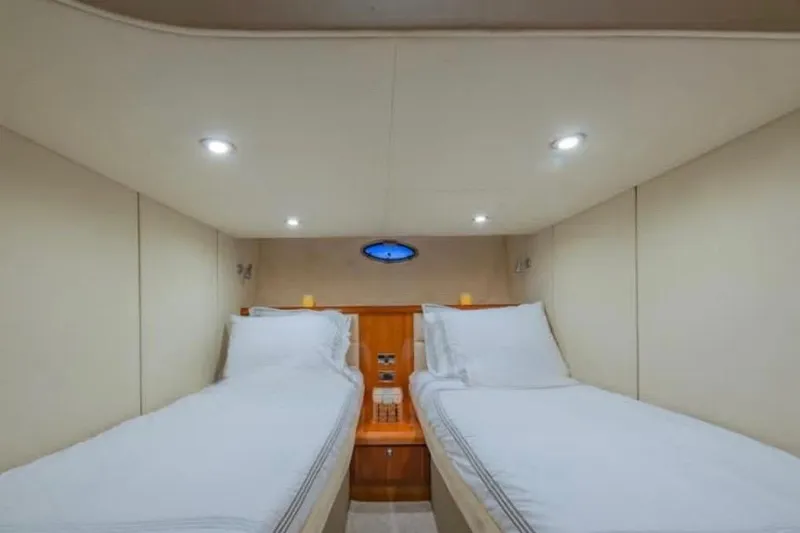  Yacht Photos Pics Interior cabin of 2006 Sunseeker Portofino 47 yacht with twin beds and modern lighting.