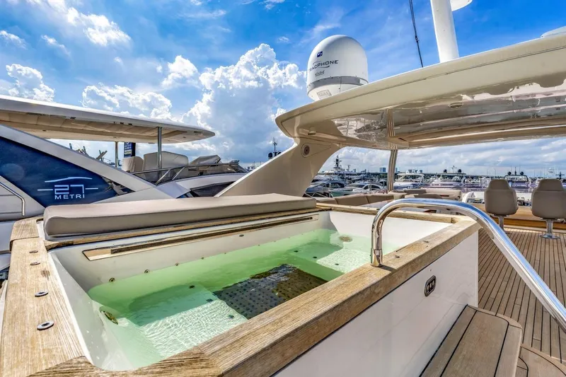 Princess Y85 Yacht Photos Pics Luxurious 2012 Princess 85 yacht with jacuzzi on deck, under a bright blue sky.