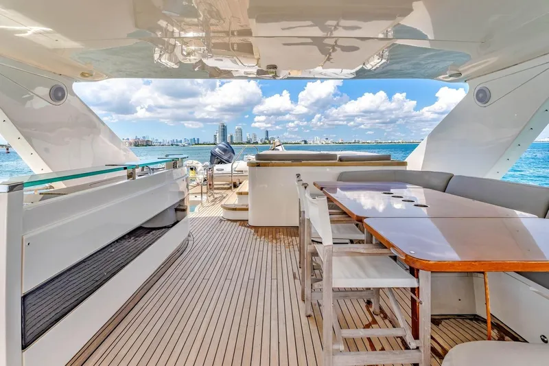 Princess Y85 Yacht Photos Pics Luxurious 2012 Princess 85 yacht deck with dining area, overlooking ocean and city skyline.