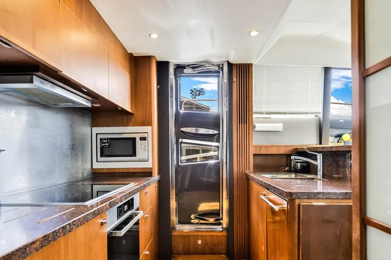 Princess Y85 Yacht Photos Pics Luxurious kitchen interior on a 2012 Princess 85 yacht, featuring modern appliances and wood finishes.