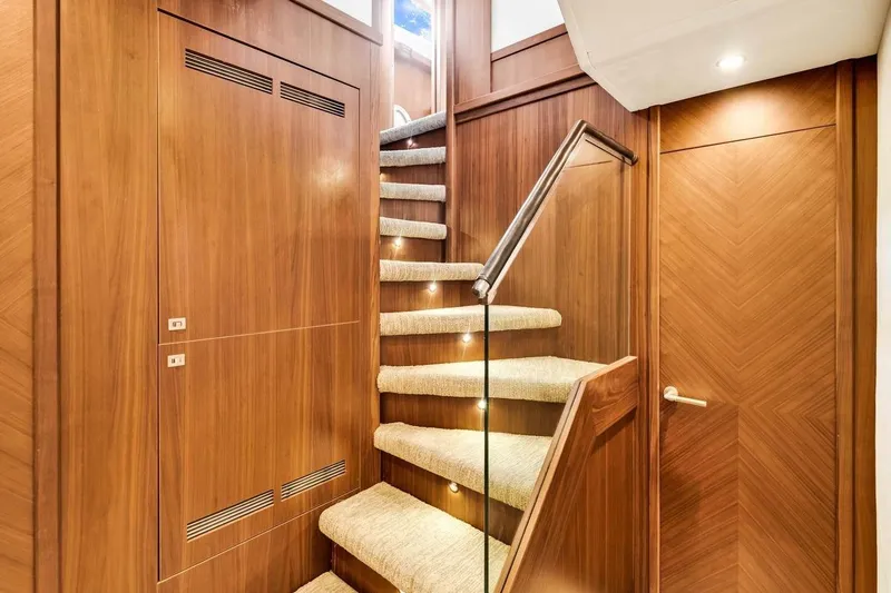 Princess Y85 Yacht Photos Pics Luxurious wooden staircase with carpeted steps on a 2012 Princess 85 yacht.