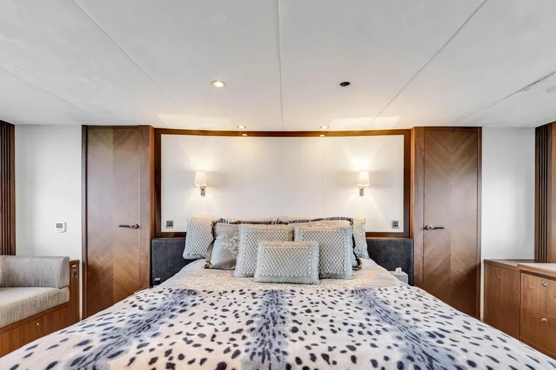 Princess Y85 Yacht Photos Pics Luxurious bedroom interior on a 2012 Princess 85 yacht, featuring elegant bedding and modern lighting.