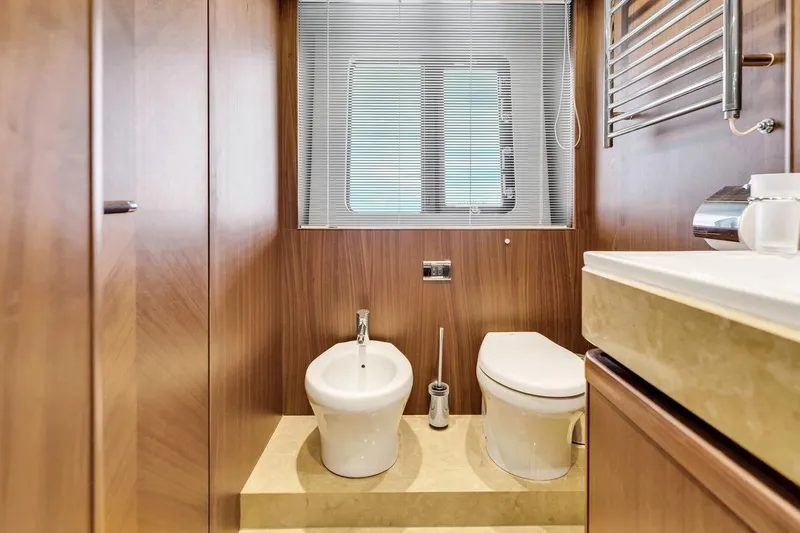 Princess Y85 Yacht Photos Pics Luxurious yacht bathroom with wood paneling, featuring a toilet and bidet. Princess 85, 2012 model.