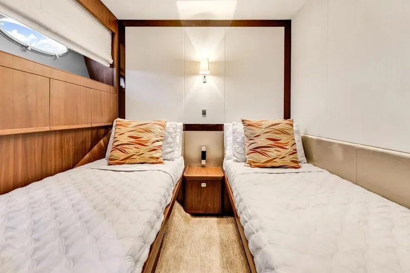 Princess Y85 Yacht Photos Pics Luxurious twin cabin interior on 2012 Princess 85 yacht, featuring elegant wood finishes.