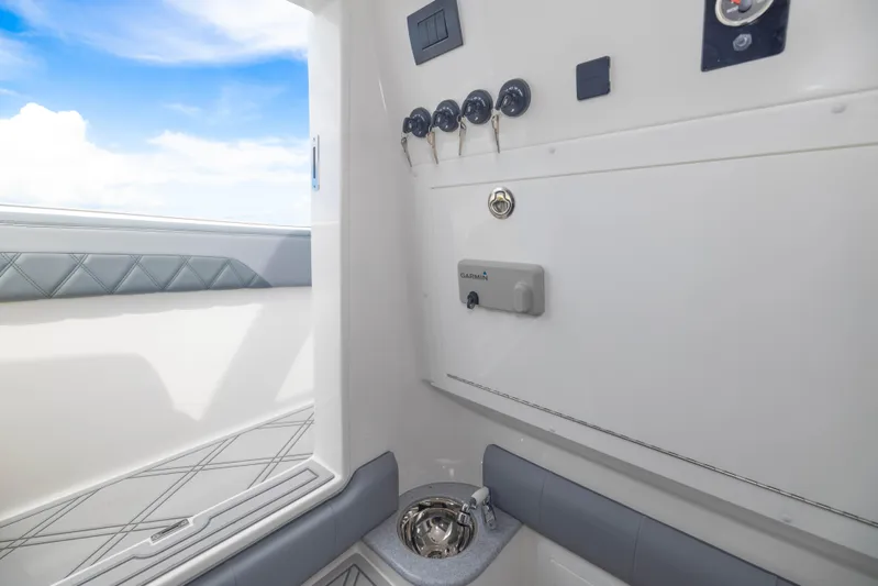  Yacht Photos Pics 2024 Deep Impact 369 boat interior with control panel and seating.