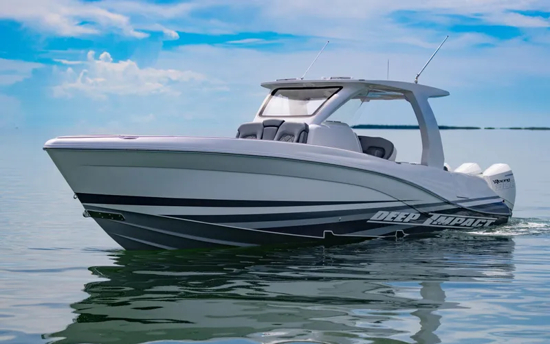  Yacht Photos Pics 2024 Deep Impact 369 boat cruising on calm waters under a clear blue sky.