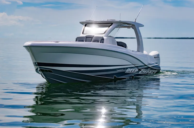  Yacht Photos Pics 2024 Deep Impact 369 boat cruising on calm waters under a clear sky.